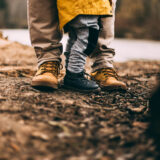 father and son in the mud