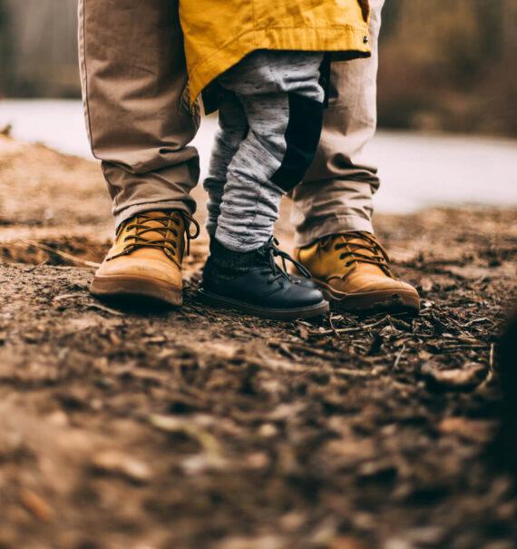 father and son in the mud